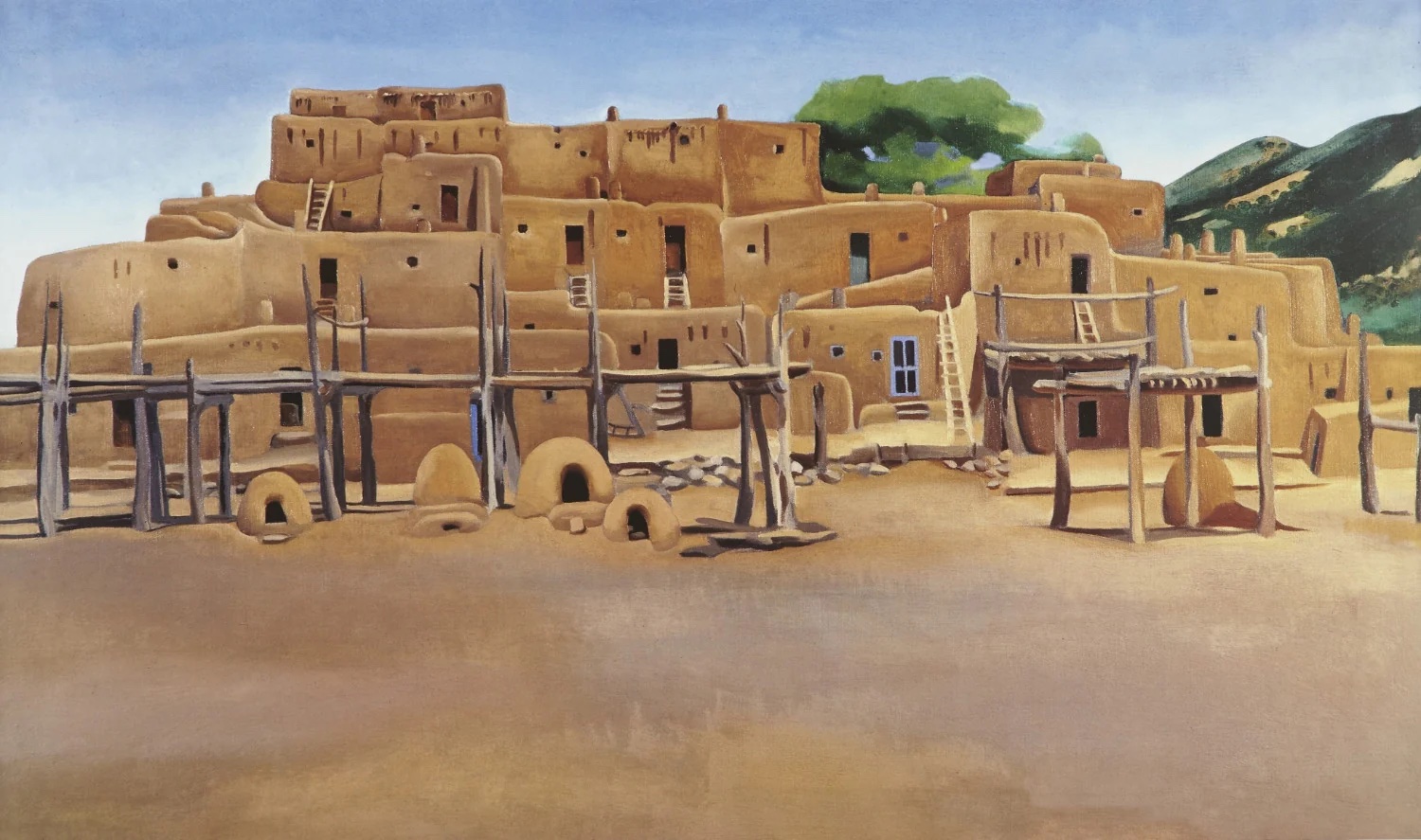An oil painting by Georgia O'Keeffe, depicting the adobe buildings of Taos Pueblo against a blue sky.