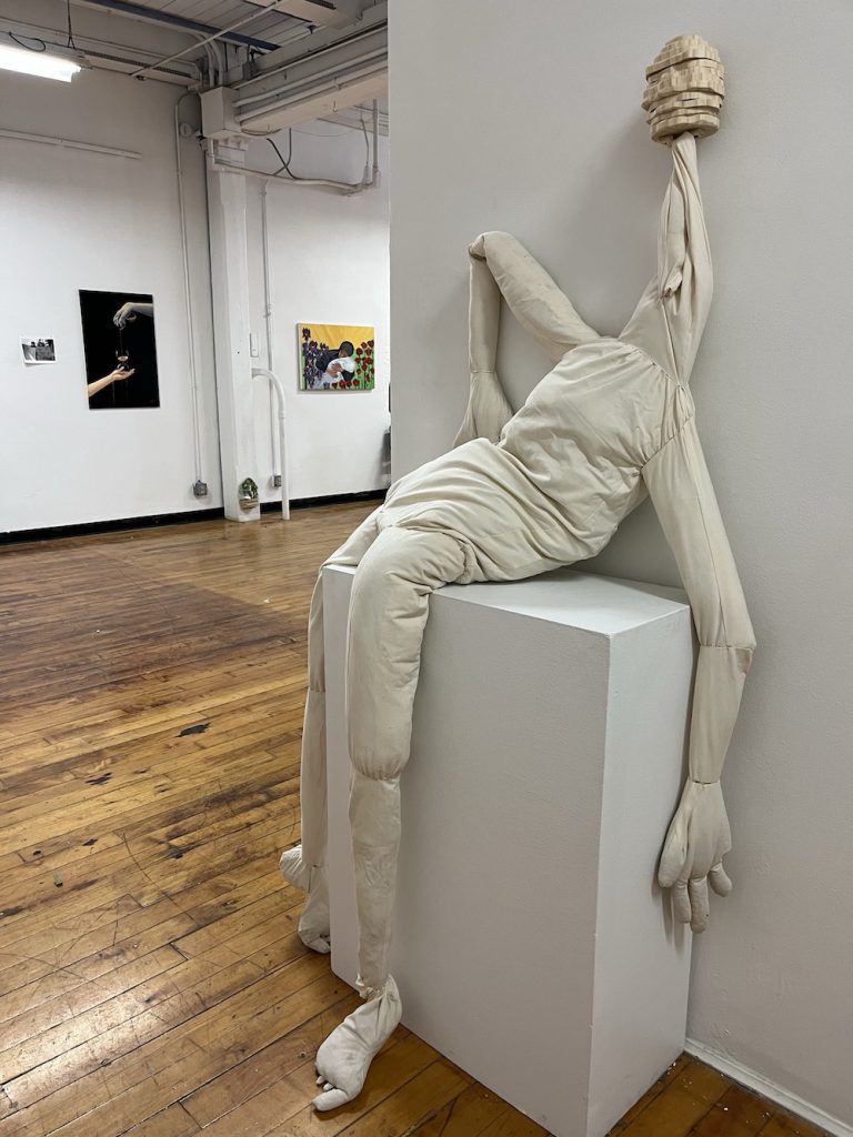 A droopy sculpture of a figure, made out of fabric